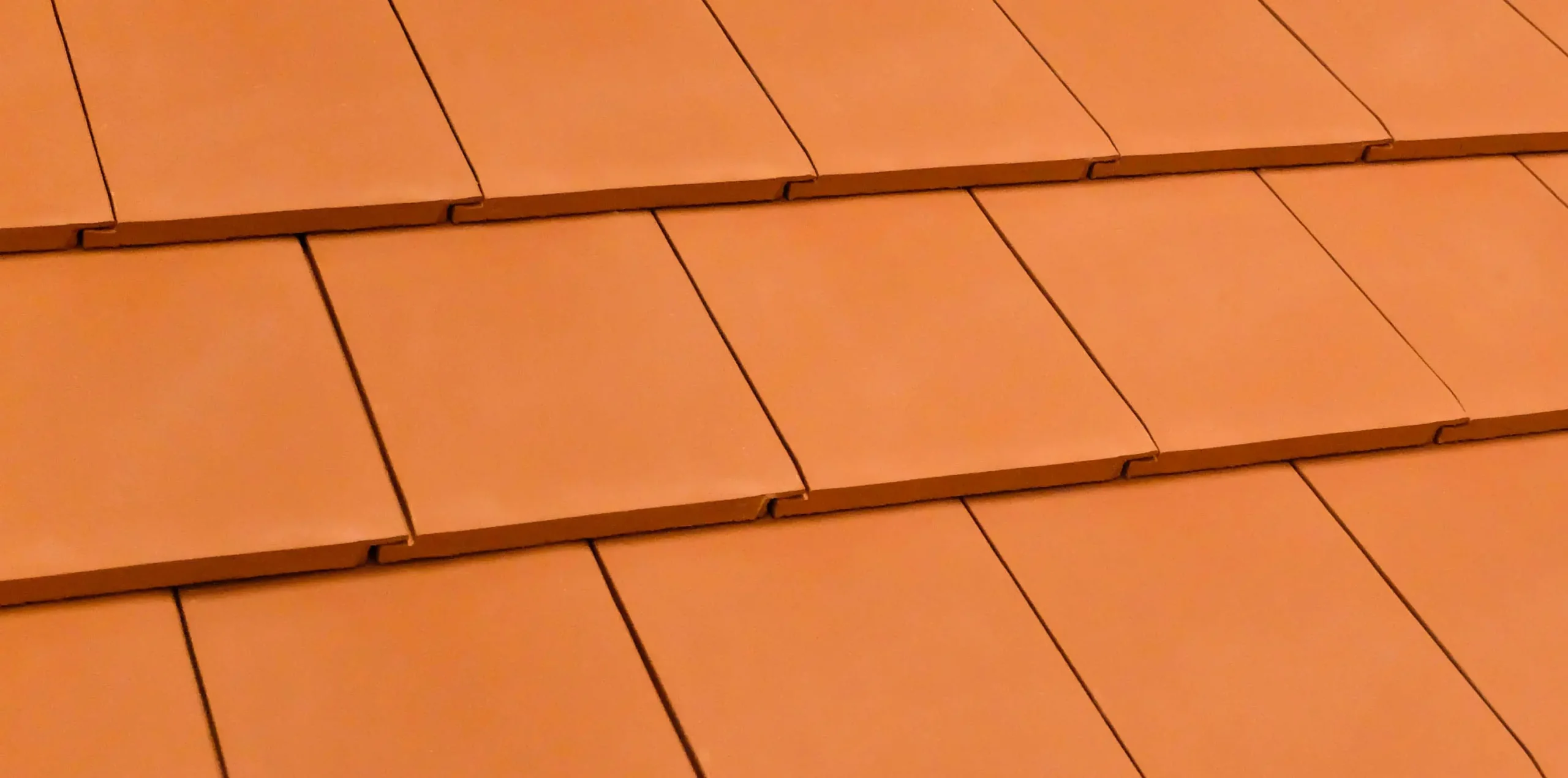 orange terracotta roof tiles overlapping rows