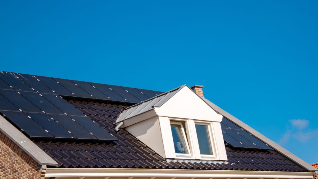 Solar panels on house roof with dormer window