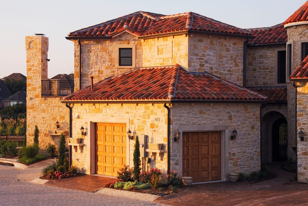 Mediterranean house stone walls wooden garage doors