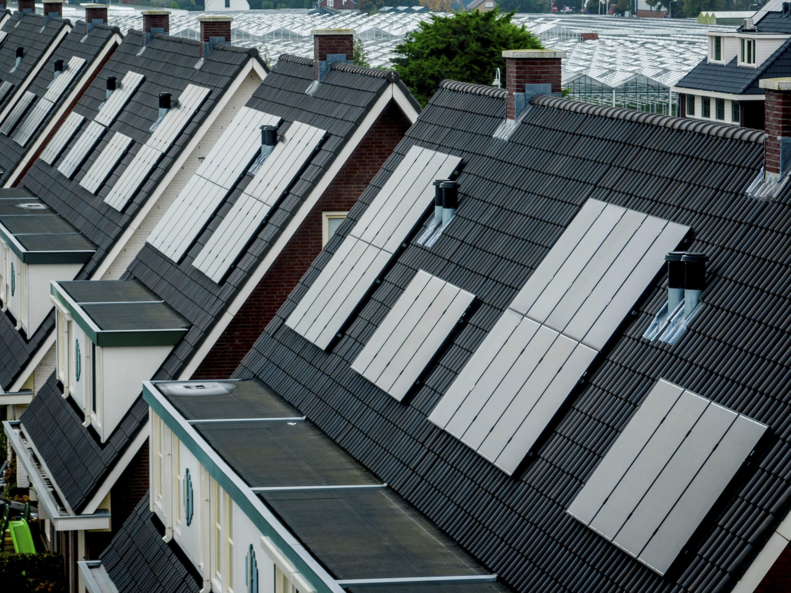 Houses with solar panels on tiled roofs