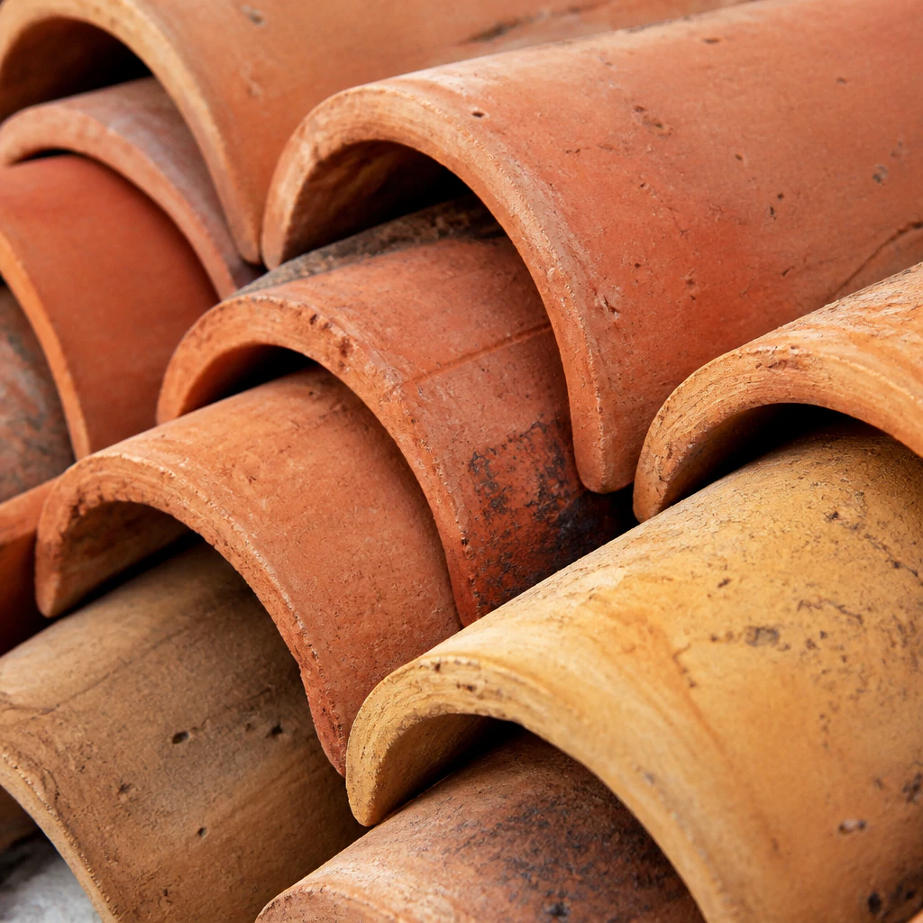 Stacked terracotta roof tiles close-up